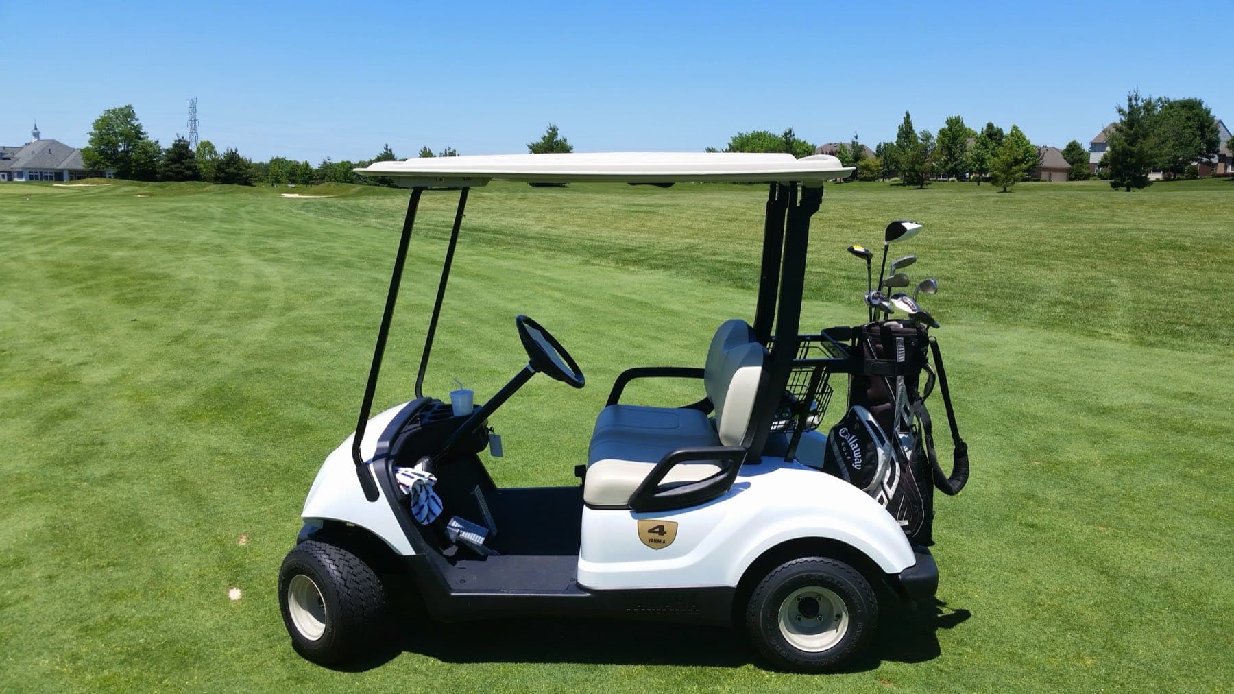 A golf cart parked on an open fairway